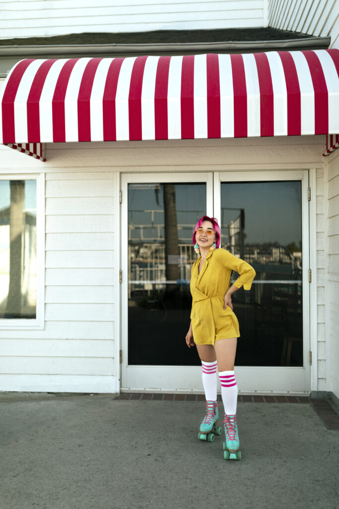 young woman with dyed hair near shop